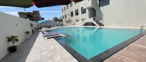 Outdoor pool, pool umbrellas, sun loungers