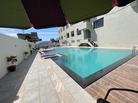 Outdoor pool, pool umbrellas, sun loungers