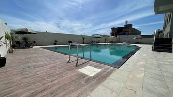 Outdoor pool, pool umbrellas, sun loungers