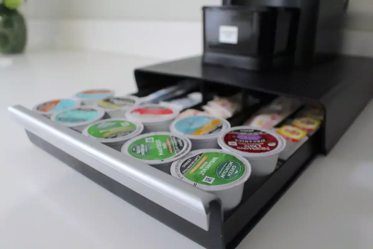 A coffee machine with multiple coffee pods on a tray.