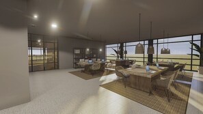 A modern office space with large windows, wooden tables, and chairs, and a bookshelf with books and laptops. - Cook's Club Calvia Beach Adults Only +21 (Calvia)