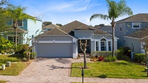 A residential house with a garage, a driveway, and a well-maintained lawn.