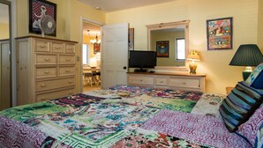 A bedroom with a large bed, a dresser, a television, and a mirror. - Condo at the popular McCloud complex (MC255) (Incline Village)