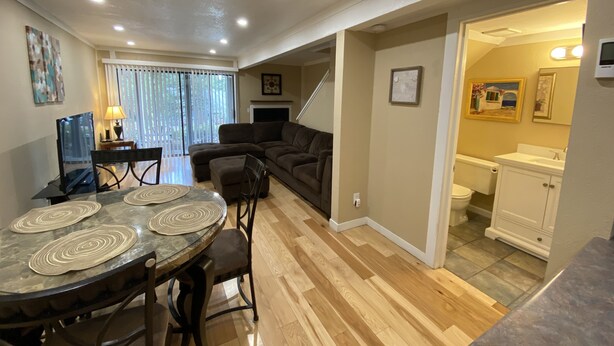 A spacious living area with a dining table, a sofa, and a kitchen area with a toilet and sink. - Cozy Condo in Incline (IM62) (Incline Village)