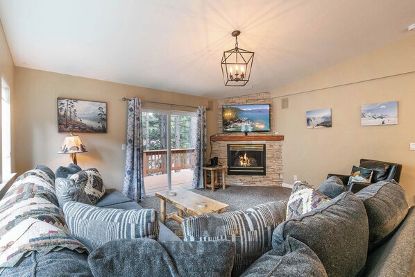 A living room with a fireplace, a television, and a sofa set.