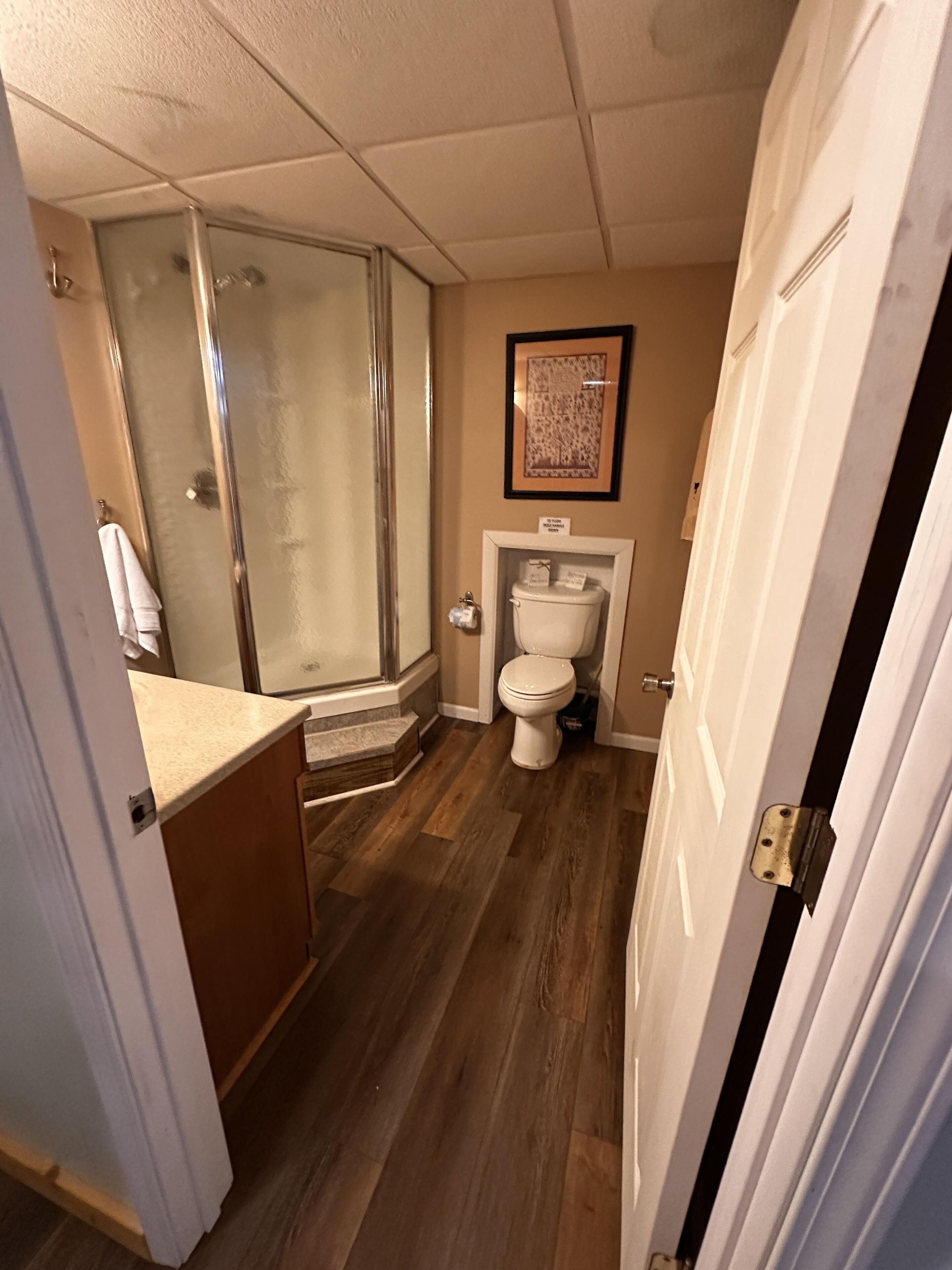 A bathroom with a shower, toilet, and sink.