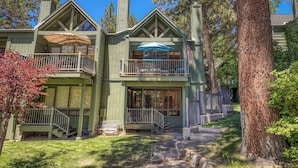 A two-story house with a balcony, a chimney, and a flag. - Lakefront Condo Complex - Beach Access (LA999 35) (Incline Village)