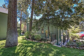 A residential property with a green exterior, a stone pathway, and a red car parked in the driveway. - Lakefront Condo Complex - Beach Access (LA999 35) (Incline Village)
