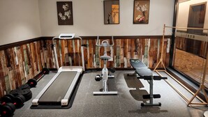 A gym with treadmills, weight machines, and dumbbells. - Nostalgia Hotel(Taiyuan Shanxi Museum) (Taiyuan)