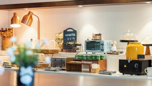 A modern kitchen with a coffee machine, toaster, and various appliances. - Nostalgia Hotel(Taiyuan Shanxi Museum) (Taiyuan)