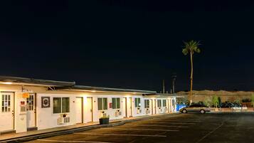Guest rooms offer porches with potted plants and easy access to parking.