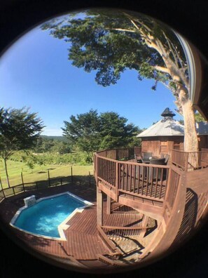 A wooden deck with a hot tub, outdoor furniture, and a gazebo. - Exotic High End Unique Off-The-Grid Treehouse, steps away from the Mopan River! (Bullet Tree Falls)