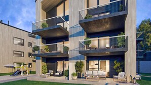 A multi-story residential building with balconies, outdoor seating, and a well-maintained lawn. - Awesome apartment in Søgne with sauna (Søgne)