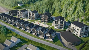 A residential area with modern houses, a central courtyard, and a forested hillside. - Awesome apartment in Søgne with sauna (Søgne)