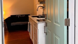 A compact kitchen with a built-in oven, a microwave, and a sink. - Lux Studio W Kitchenette Pets are allowed (Beaufort)