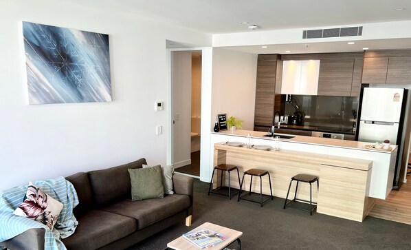 Un appartement moderne comprenant un salon, une kitchenette et un coin repas.