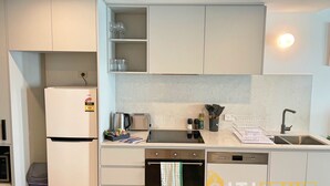 A compact kitchen with a refrigerator, toaster, oven, and sink. - Splendid 2bd 1bth 1csp Apt - Superb CBD Location (Reid)