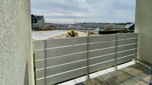 A balcony with a view of a marina and buildings.