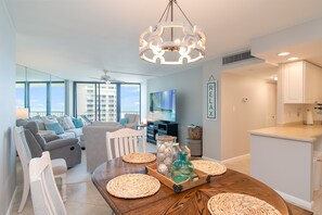 Enjoy meals together at the spacious dining table, surrounded by comfortable seating and a large window offering a view of the outside.