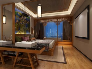 Un dormitorio moderno con una cama grande, un tocador con espejo y vistas a la ciudad.
