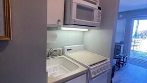 A compact kitchen with a microwave, sink, and stove. -    LAST MINUTE VACATION?  JULY 20-JULY 22.  LOW RATES. (Moneta)