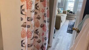 A room with a view of a living area, a beige sofa, and a patterned curtain. -    LAST MINUTE VACATION?  JULY 20-JULY 22.  LOW RATES. (Moneta)