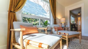 A room with two wooden chairs with cushions, a small table, and a window with curtains. - 5 Bedroom Home Downtown, Close to shops! (Chelan)