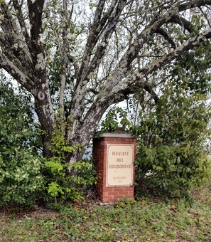 Discover the charm of Pleasant Hill's historic neighborhood, surrounded by lush greenery and mature trees.