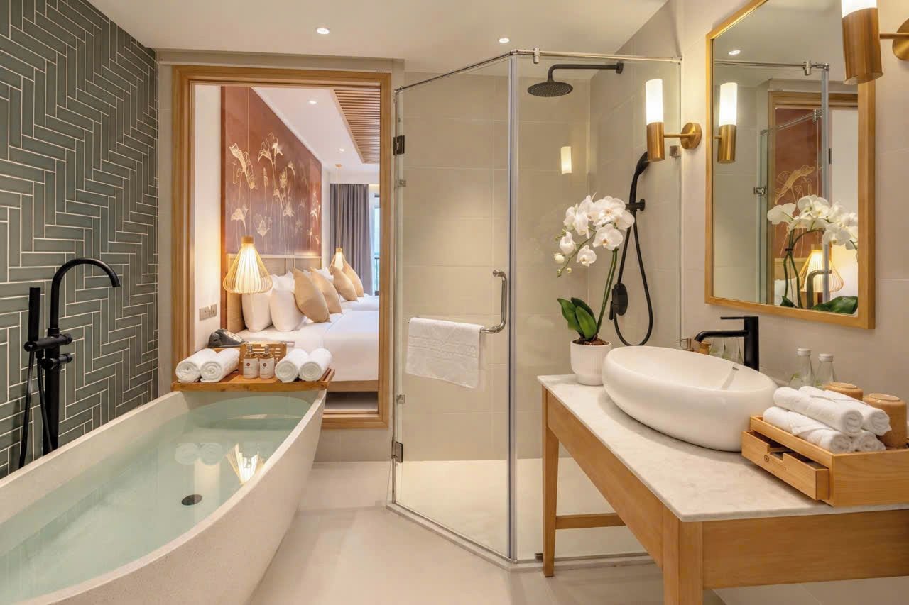 A modern bathroom with a freestanding bathtub, a glass-enclosed shower, and a vanity with a mirror.