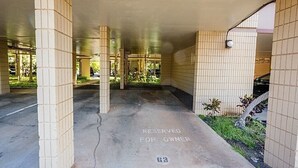 A covered parking area with a 'RESERVED FOR OWNER' sign on the floor. - Beautiful Kihei Condo with Ocean & Haleakala Mountain Views (Kihei)
