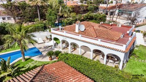 A villa with a swimming pool, outdoor seating, and a covered patio area. - Beachfront Villa Casa Mosa | Ref. #32 (Marbella)