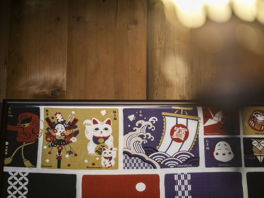 A wooden surface with a framed collection of Japanese artwork.