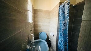 A bathroom with a sink, toilet, and shower curtain. - Abrama Bed And Breakfast (Francistown)