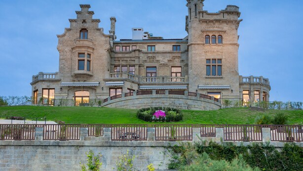 A large, historic stone building with multiple towers and a central courtyard. - Palacio Arriluce Hotel (Getxo)
