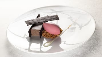 A dessert on a white plate with a spoon.