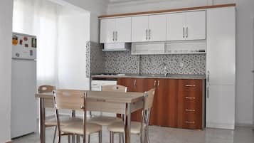 City Apartment | Private kitchen | Full-size fridge, stovetop, cookware/dishes/utensils, cleaning supplies