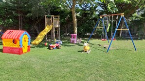 A playground with a slide, swings, and a playhouse. - Villa with Breathtaking Seaview, Private Swimming Pool & Jacuzzi (Corfu)
