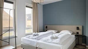 Hotelkamer met een bed, twee nachtkastjes, een raam met gordijnen en uitzicht.