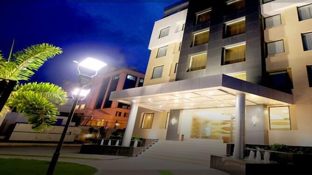 A multi-story hotel with a modern design, featuring a covered entrance and multiple balconies. - Hotel DORTN (Paud)