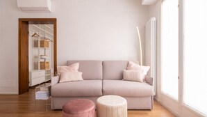 A modern living room with a neutral color palette, a sofa, a coffee table, and a wooden floor. - Venetian Palace Gold Apartment with Balcony R&R (Venecia)