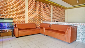 A corner seating area with a brick wall and a tiled backsplash.