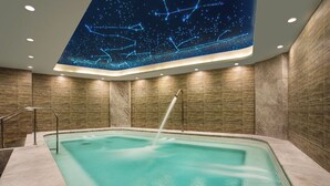 A modern indoor pool with a starry ceiling design, surrounded by wooden walls and equipped with a water fountain. - Somerset Taihu New City CBD Wuxi (Wuxi)