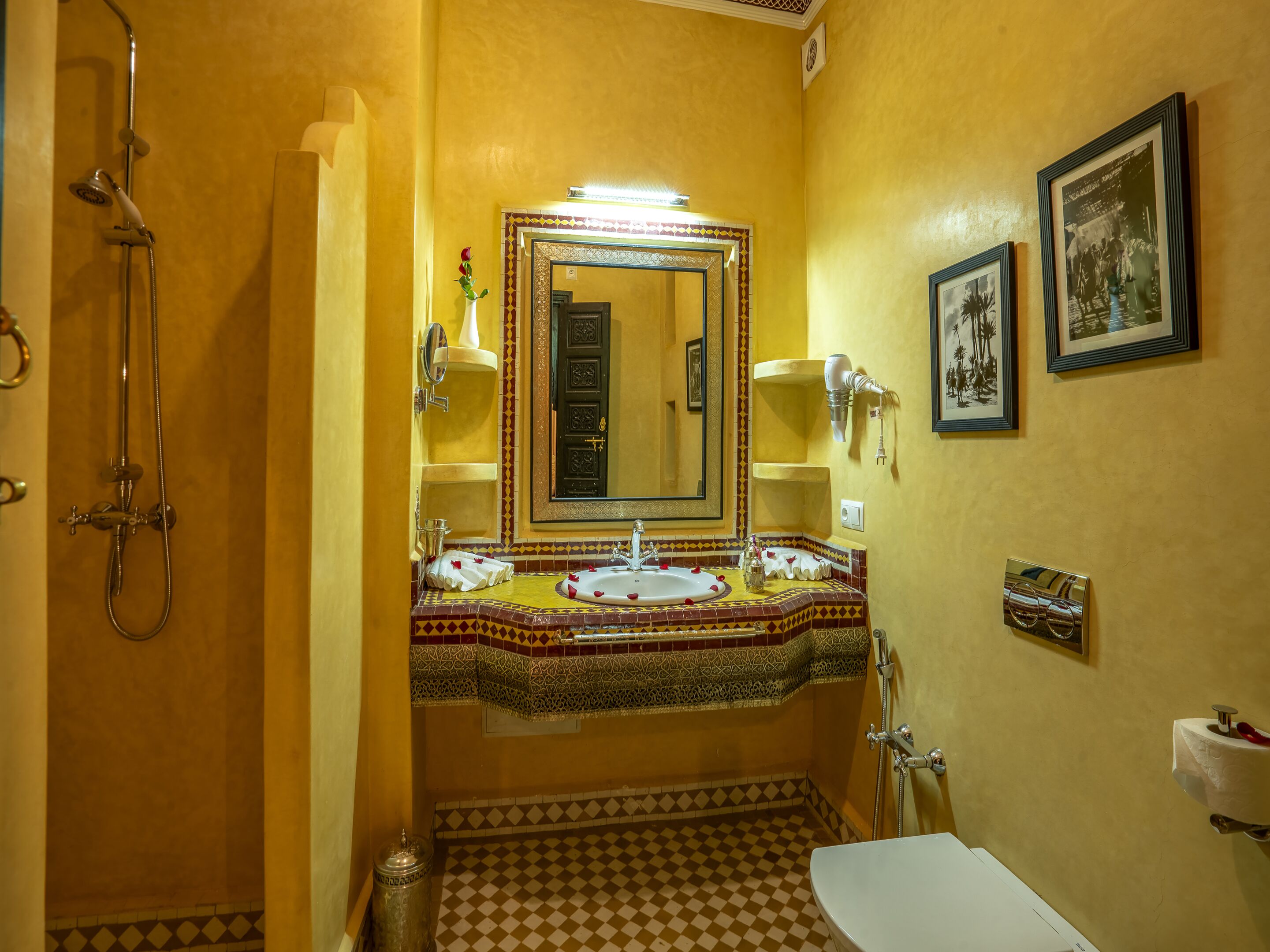 A bathroom with a shower, sink, and toilet.