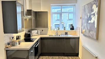 Fridge, oven, cookware/dishes/utensils, dining tables
