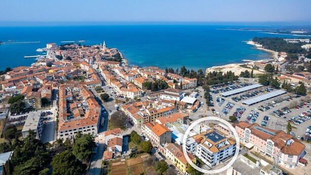 An aerial view of a coastal town with historic buildings, a marina, and a large parking area. - Apartment with Balcony No.18 in Nar Residence (Porec)
