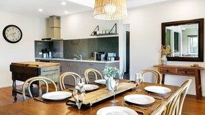A modern kitchen with a dining area set for six. - Alpine Twin Heights (Merrijig)