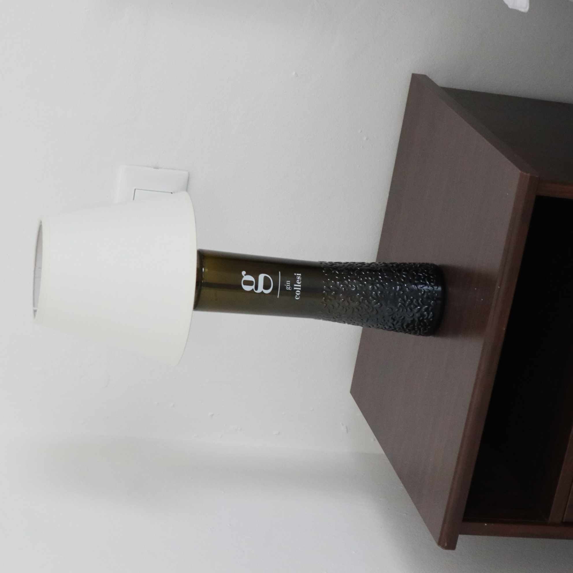 A bottle of wine on a wooden surface.
