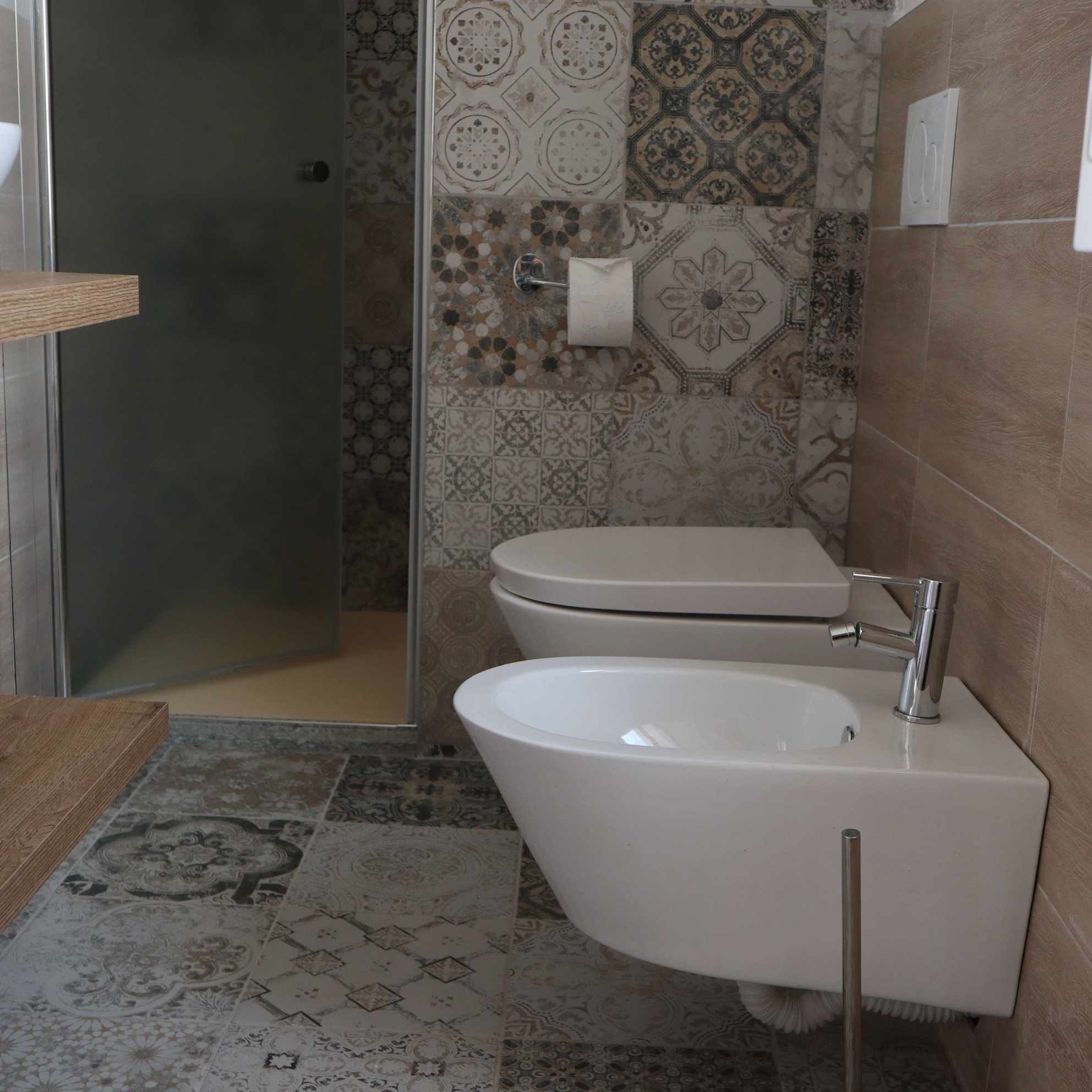 A bathroom with a shower, toilet, and sink.