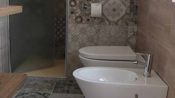 A bathroom with a shower, toilet, and sink.