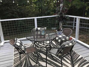 Relax in this inviting outdoor seating area with a round table and four comfortable chairs.